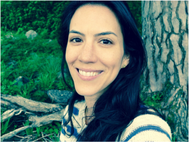 Portrait of Flor Sylvester outdoors beside a tree